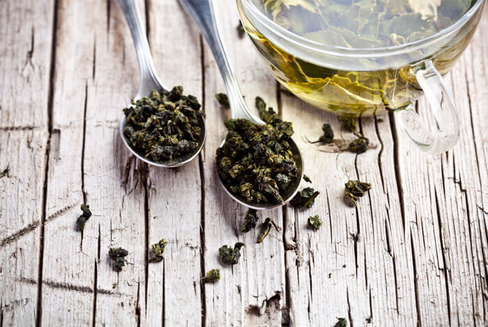 green tea leaves spoon cup