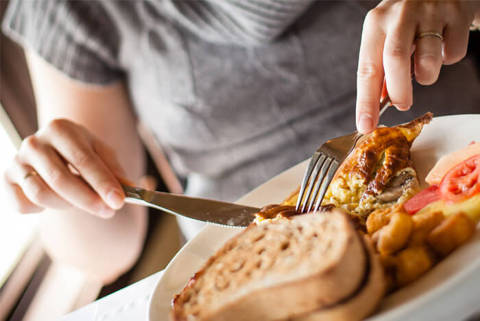 woman eating breakfast big plate