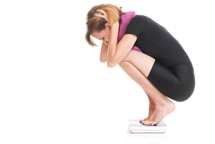 woman on scales weight gain