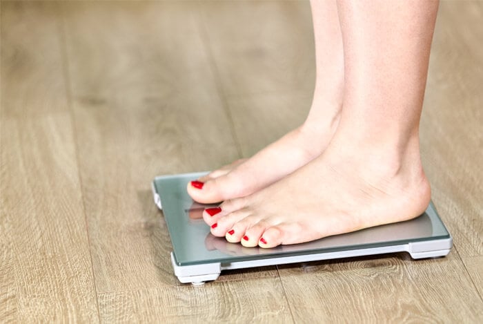 woman on weight scales