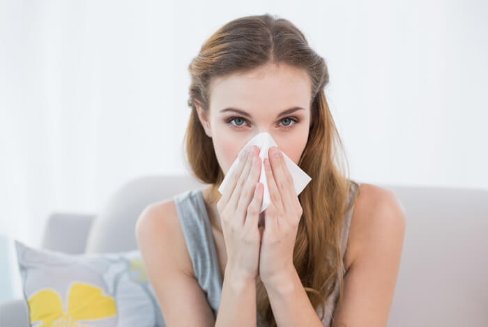 woman sneezing