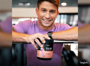 Athlete reviewing the difference between pre workout and creatine by holding Pulse pre-workout.
