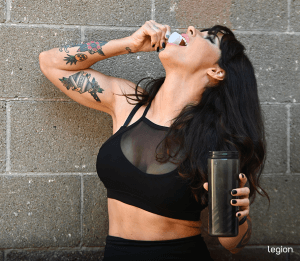 Female athlete dry scooping pre-workout