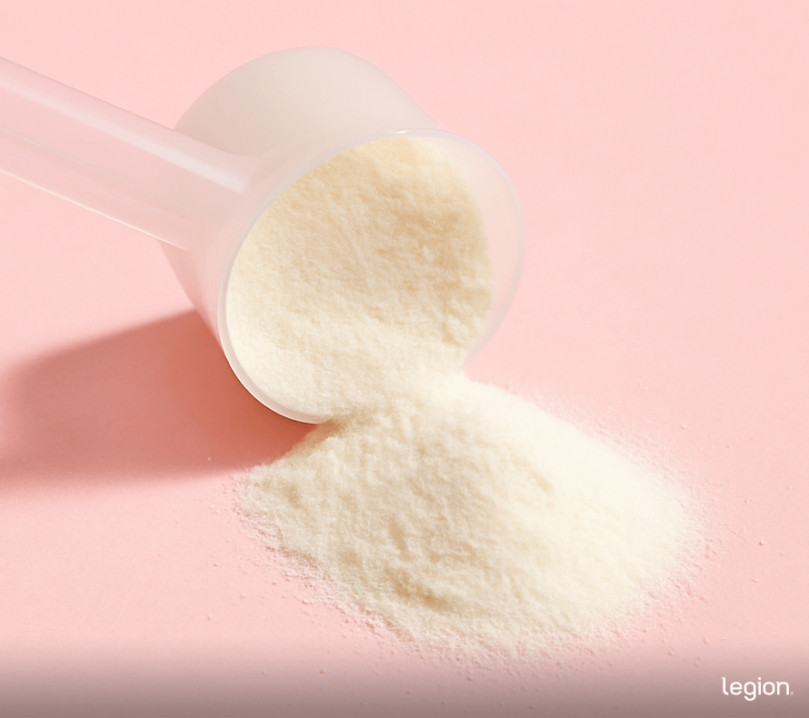 Scoop of collagen protein powder poured out on table.
