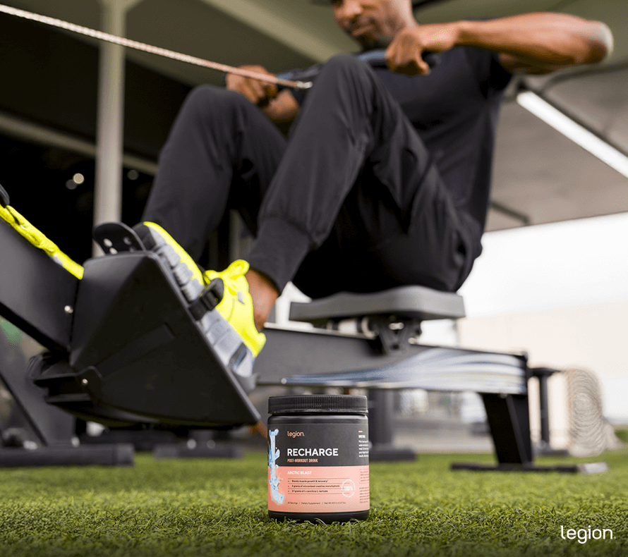 Male athlete rowing with creatine, wondering “is creatine pre workout?”