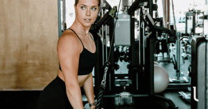 Female doing triceps pushdown to finish her chest and shoulder workout for women.