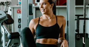 Female sitting in the gym between sets of exercises to lift sagging breasts