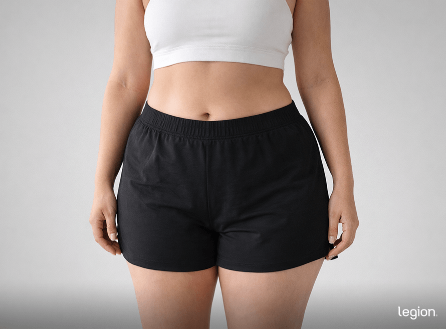 Female midsection in workout leggings illustrating what hip dips look like