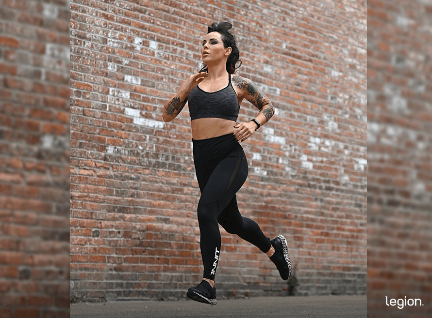 Woman running on the street as part of a plan to lose FUPA.