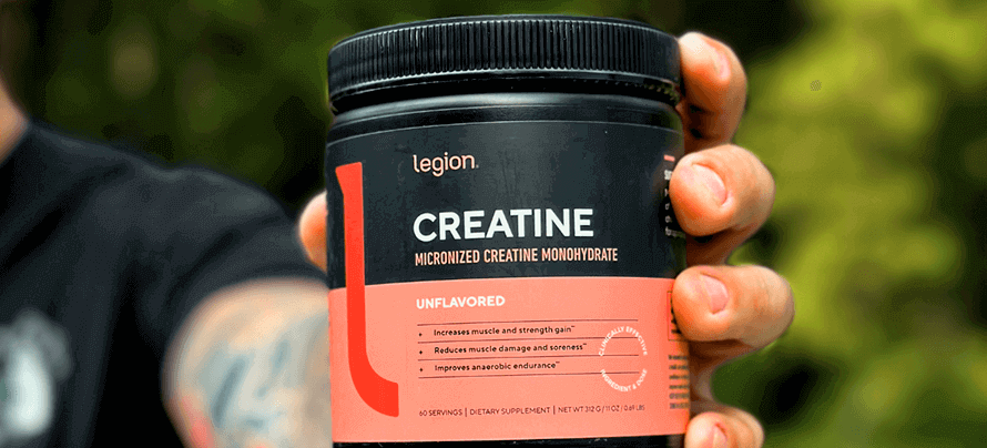 Athelte holding tub of creatine monohydrate—a better solution to creatine HMB.
