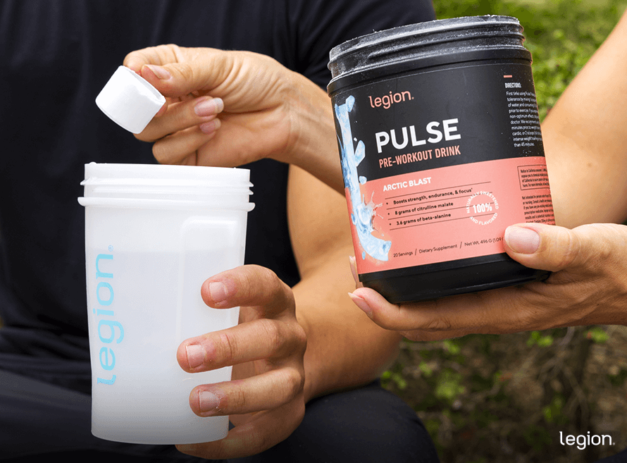 Two athletes preparing a pre-workout drink, showing what pre-workout feels like when used properly before training.