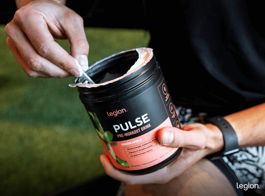 Close-up of athlete mixing pre-workout supplement, showing how using the right pre-workout affects energy, focus, and workout performance.