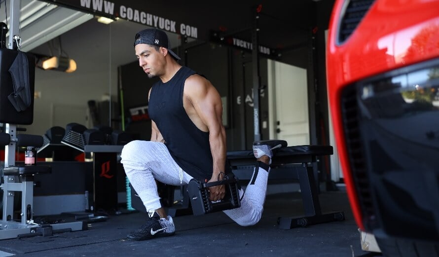 Athlete doing a dumbbell leg workout to train quads, glutes, and hamstrings