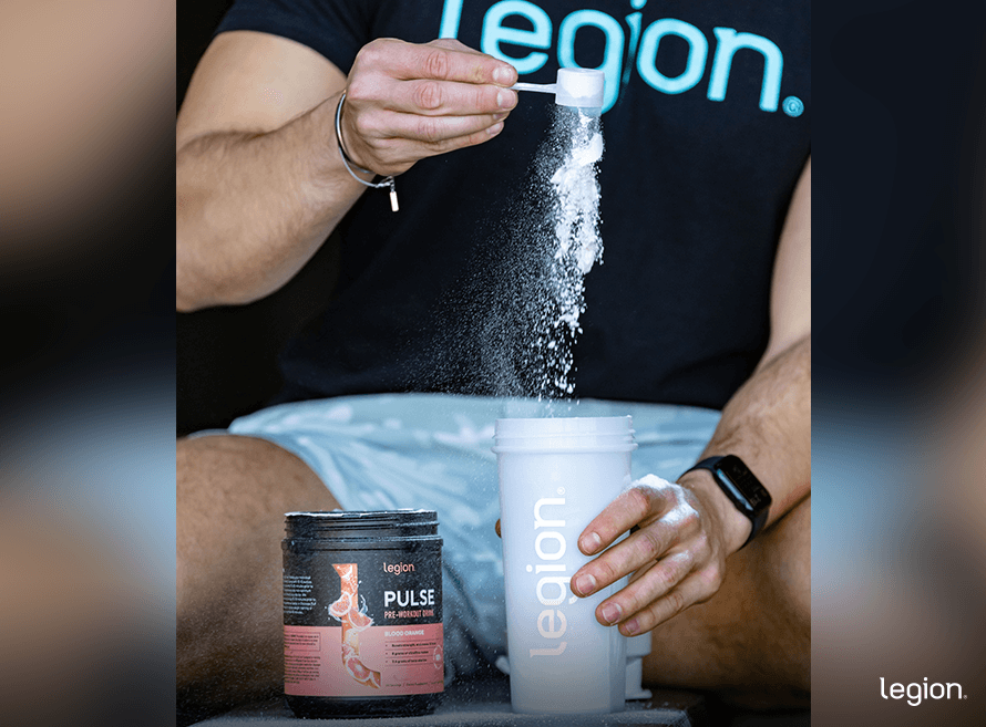 Male athlete preparing pre-workout while fasting, demonstrating when pre-workout can be taken without breaking a fast.