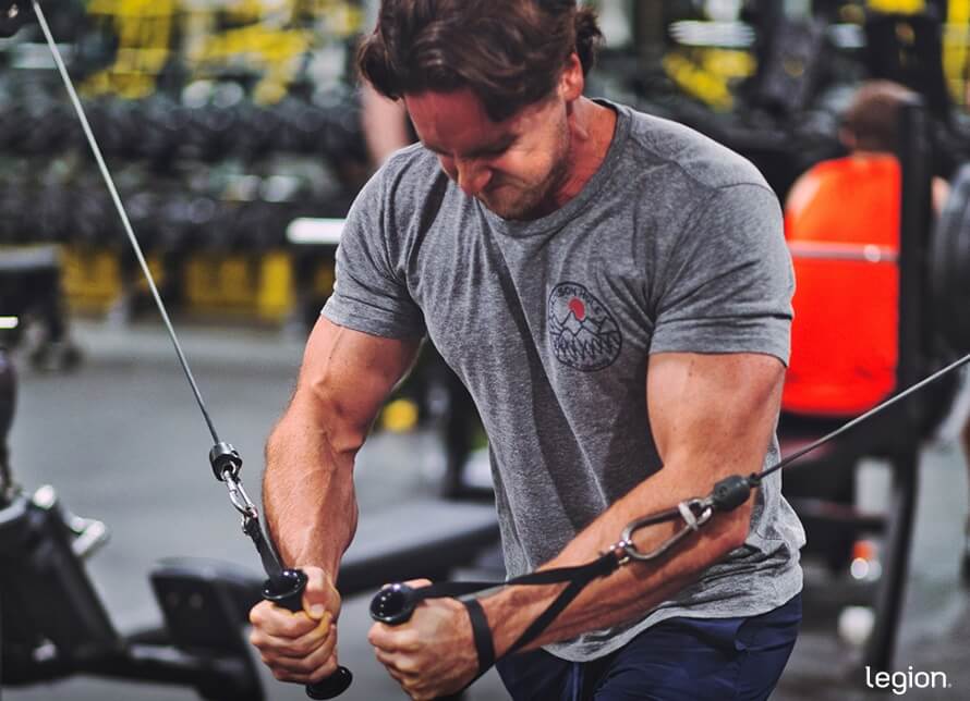 Male athlete doing cable flyes during a chest and back day.