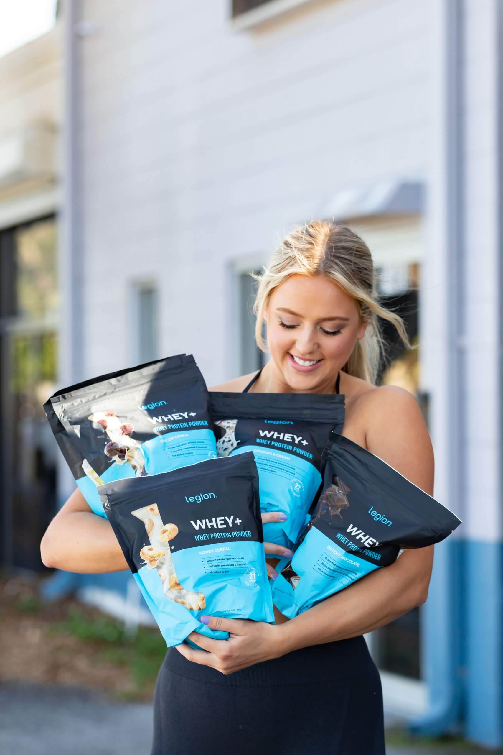Woman drinking from a Legion shaker bottle