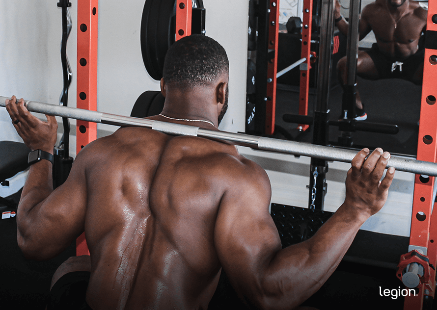 Male athlete performing a barbell squat during a Doggcrapp training session illustrating the high-intensity DC training style