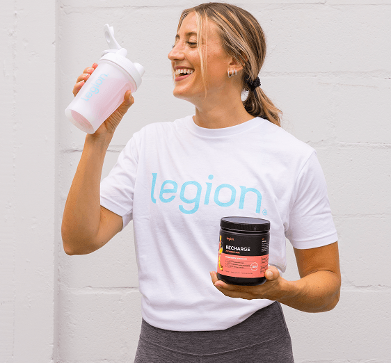 Woman drinking from a Legion shaker bottle