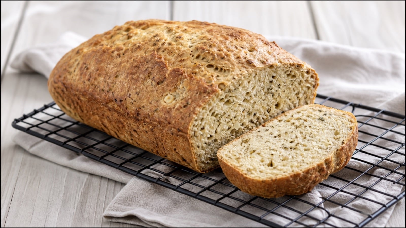 Close dill and cottage cheese bread showing its browned crust and soft sliced crumb