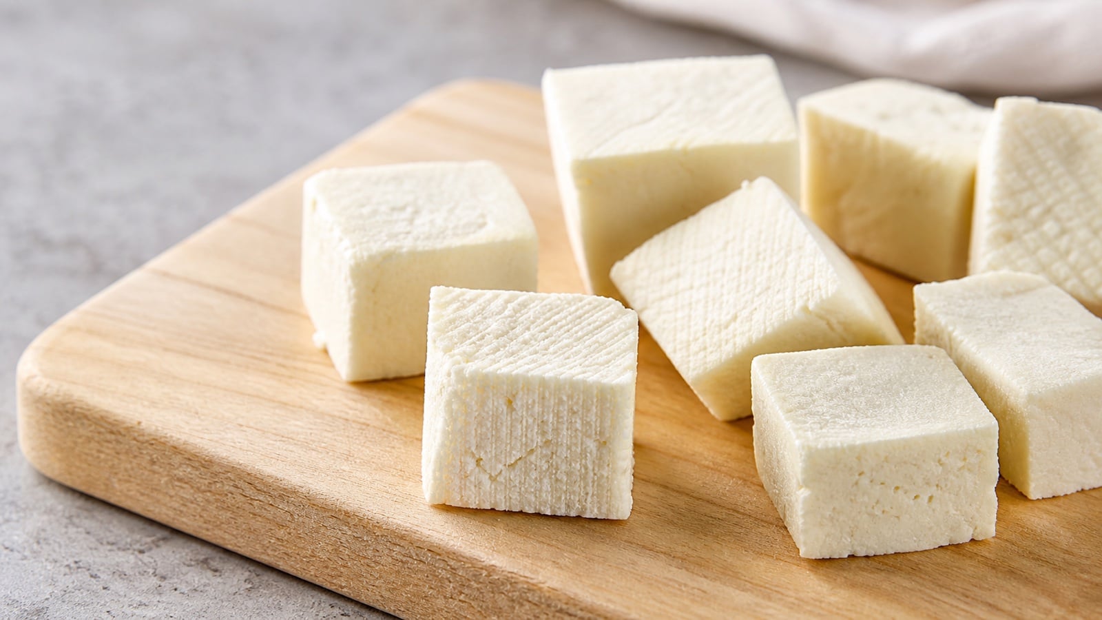 Close cubes of homemade paneer showing their fresh pressed-curd texture