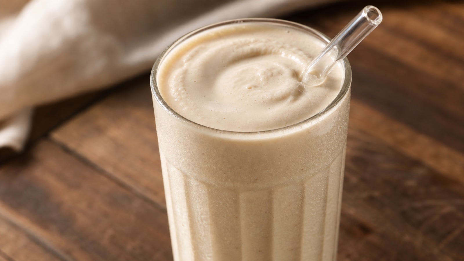 A close glass of thick peanut butter maple cottage cheese protein shake