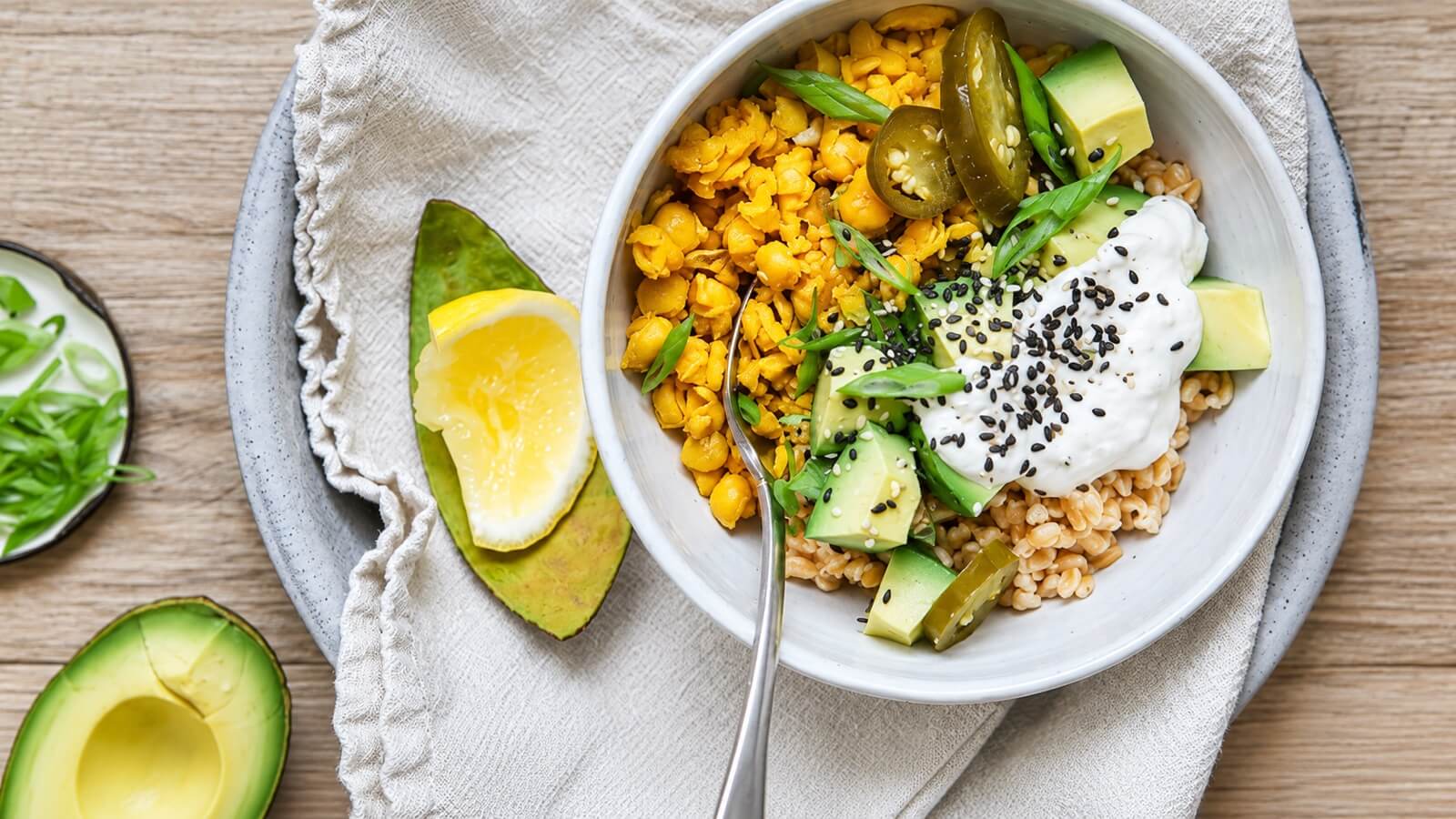 Farro bowl with turmeric chickpeas, avocado, jalapeño, and sauce