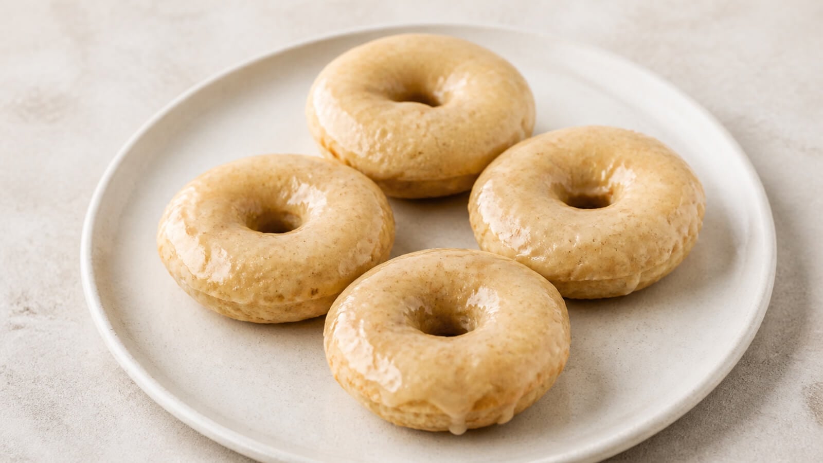 Four maple-glazed vanilla protein donuts