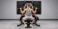 Rear view of a man performing a machine lat pulldown at the bottom of the rep.
